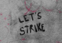 "Lets strike" graffitied on a wall