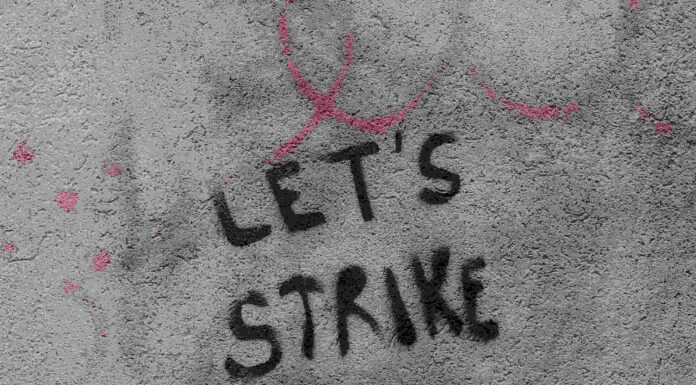 "Lets strike" graffitied on a wall